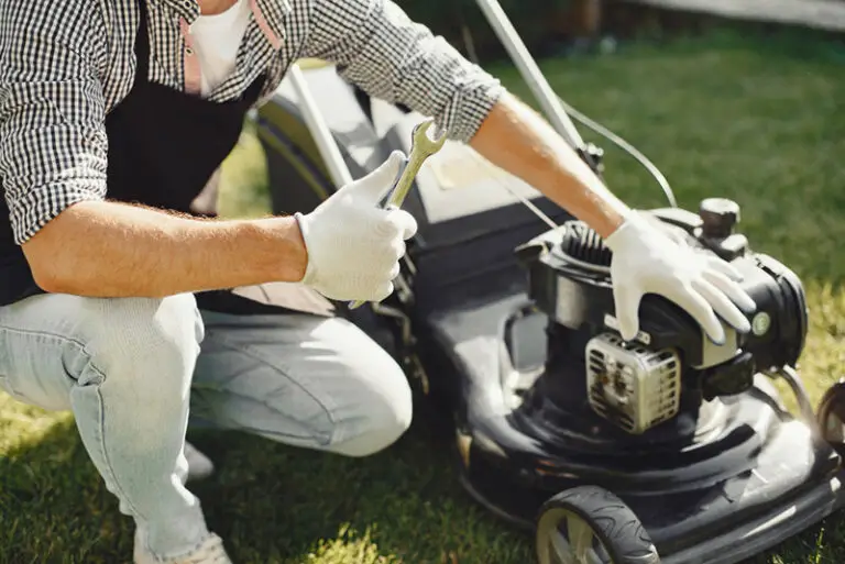 man working on lawn mower